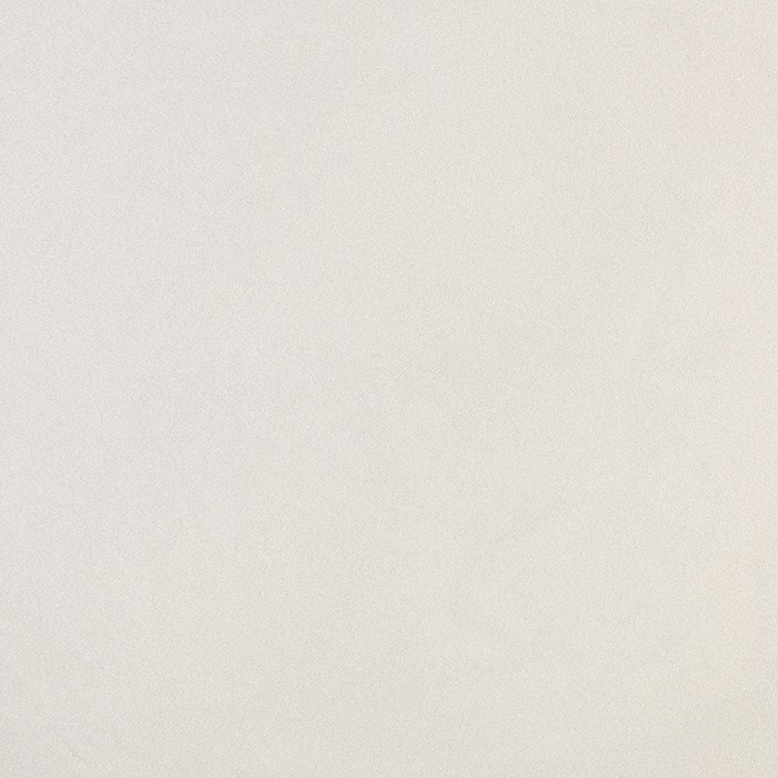 Nahaufnahme einer hellbeigen, strukturierten Oberfläche mit feiner Körnung und dezenten Farbunterschieden, die an Papier oder Putz erinnert.