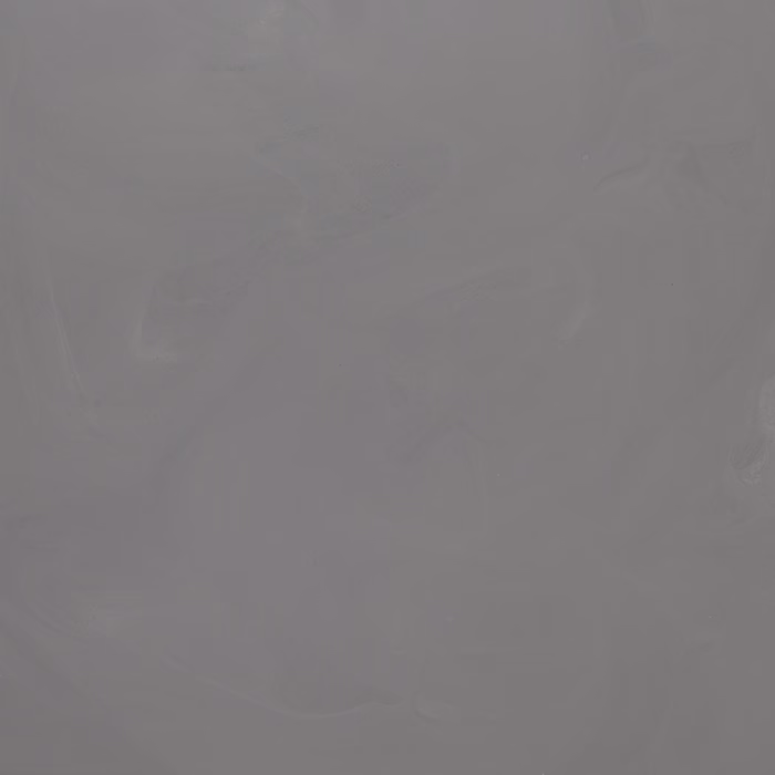 Eine glatte, einfarbige graue Oberfläche mit subtilen Variationen und Wirbeln, die einen beruhigenden und friedlichen visuellen Effekt erzeugt.