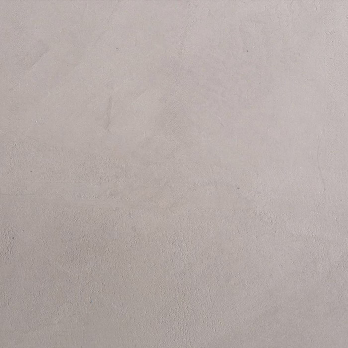 Eine strukturierte Oberfläche, die anscheinend aus Putz oder Beton besteht, in einem hellgrauen Farbton mit subtilen Variationen in der Tönung und einer glatten Oberfläche.
